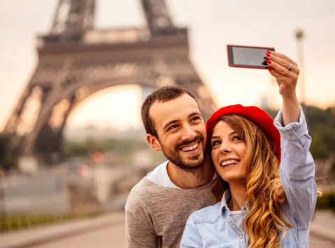 Eiffel Tower tickets with audioguide: visitor listening at the tower